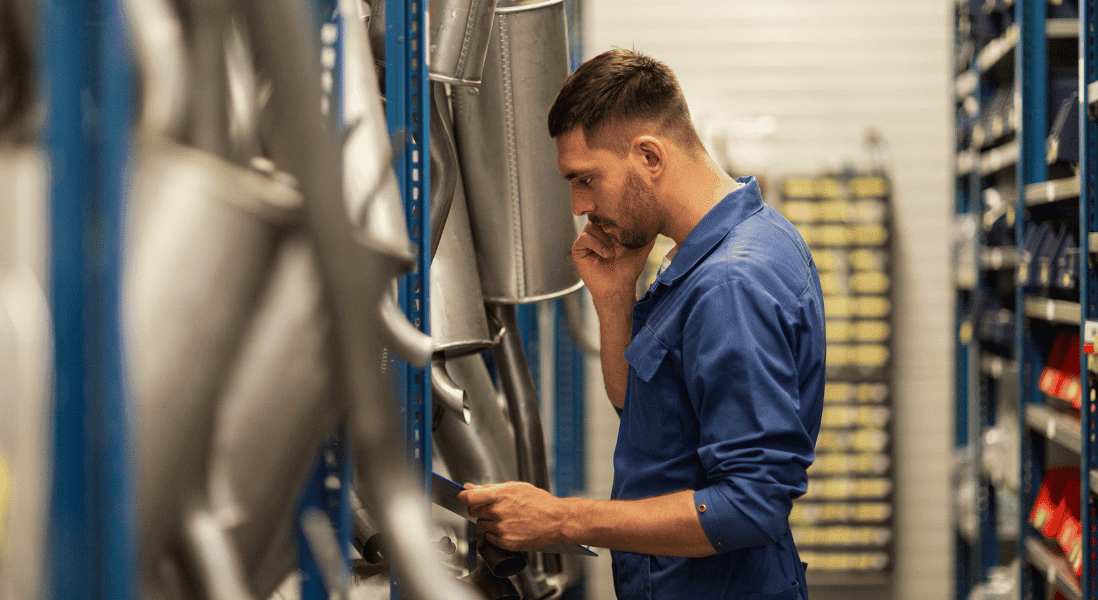 a guy wearing a blue jump suit on the phone call