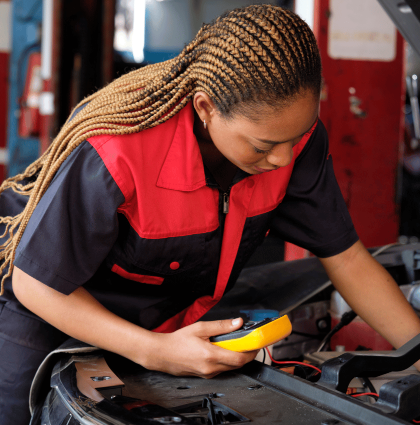 female mechanic , multi meter , open bonnet